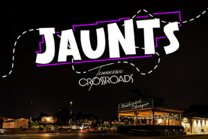 "Jaunts" in large letters above "Tennessee Crossroads." The words are placed on top of a photo of a city street at night.