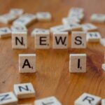 Scrabble tiles spelling news AI